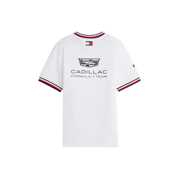 A white short-sleeve crewneck t-shirt featuring the Cadillac Formula 1 Team logo on the chest, with red, white, and navy blue striped ribbed trim on the collar and sleeve cuffs.