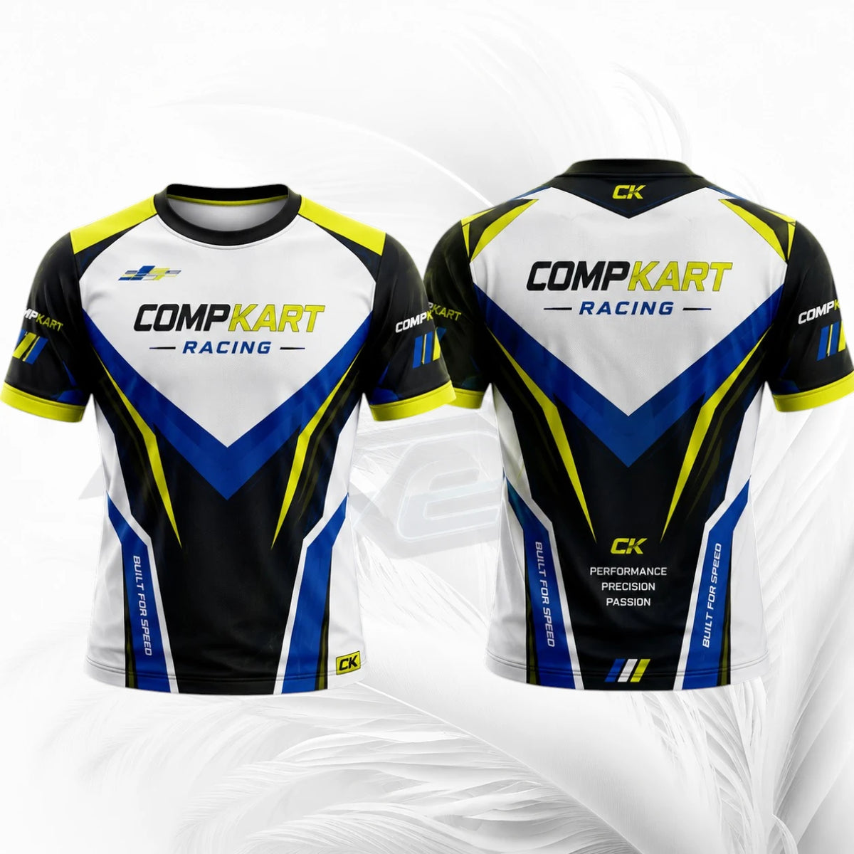 Front and back views of a short-sleeve Comp Kart Racing cycling jersey. The jersey features a white, black, blue, and yellow color scheme with 'COMPKART RACING' printed across the chest and back, and a small yellow 'CK' logo on the collar and lower hem.